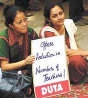 Teachers protest outside the UGC building on Monday against two circulars issued by the commission that seek to increase the teachers’ workload and decrease their numbers